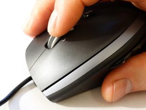 Man using mouse to click on website button