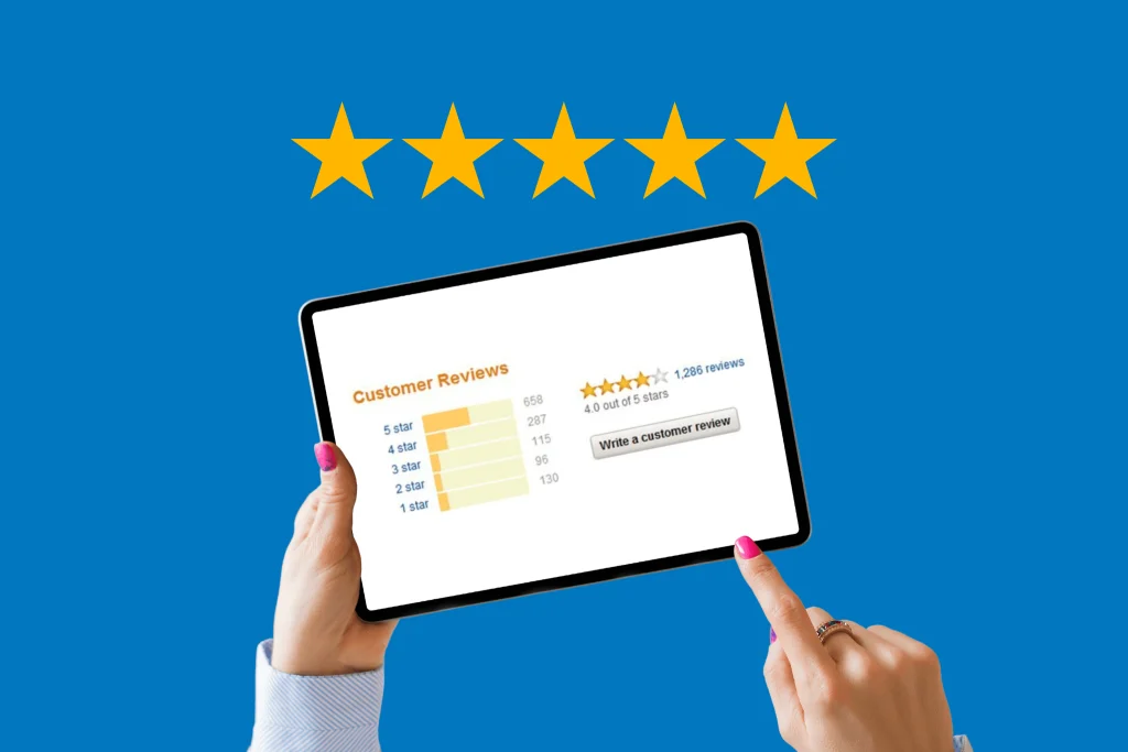 Woman holding up tablet while leaving a 5 star review